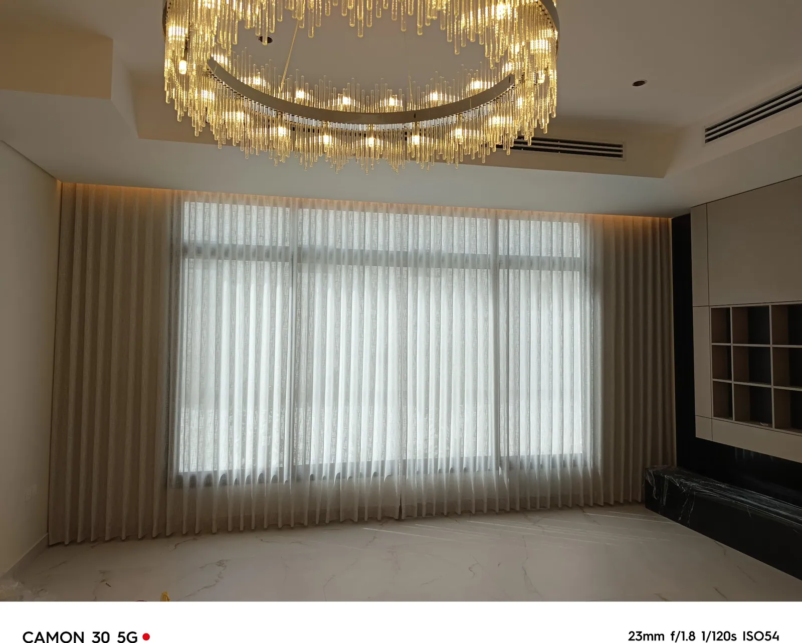 Sheer majlis curtains and brass chandelier in a luxury Dammam villa