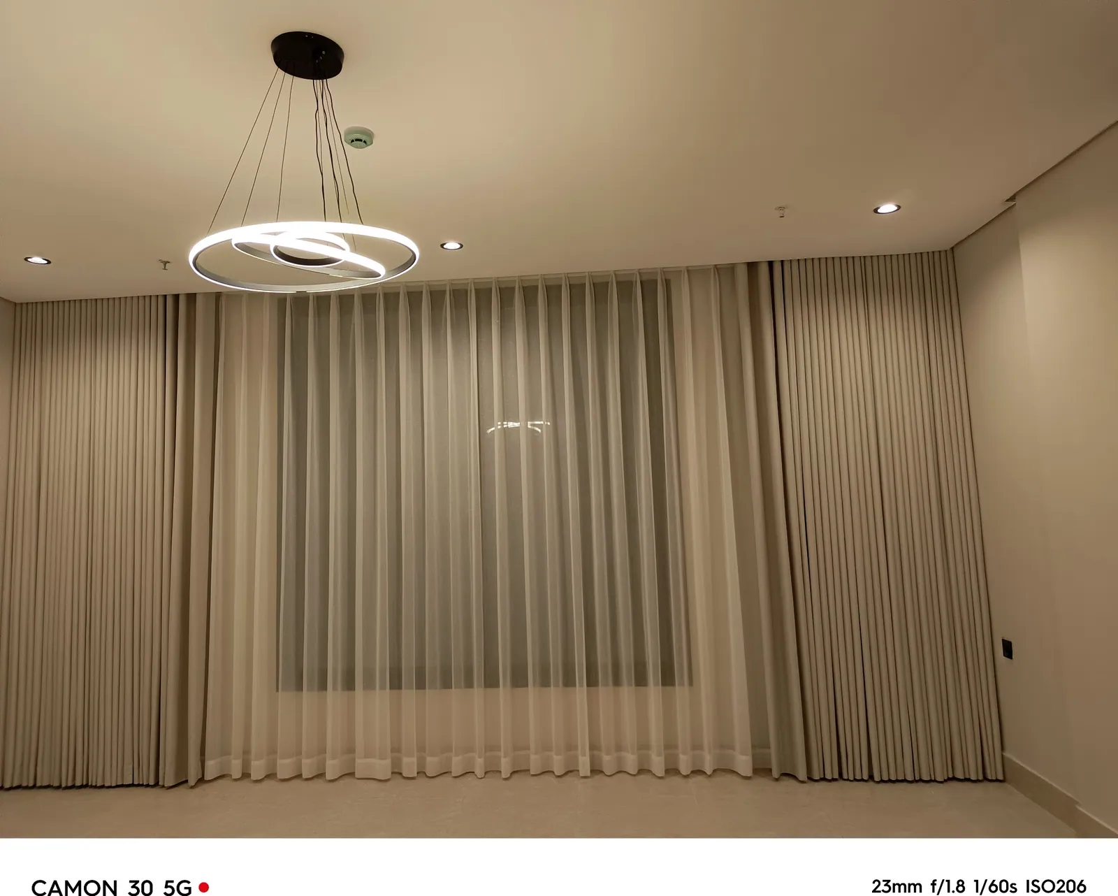 Full wall wave curtains in a family living room in Dhahran