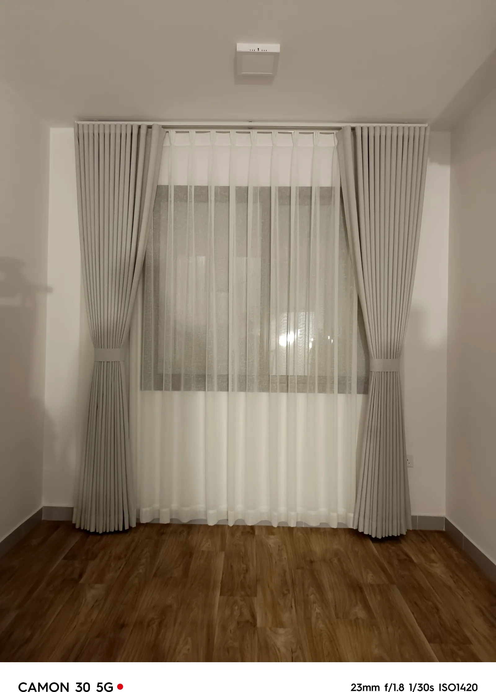 Tailored sheer curtain panel over a bedroom window in Dammam