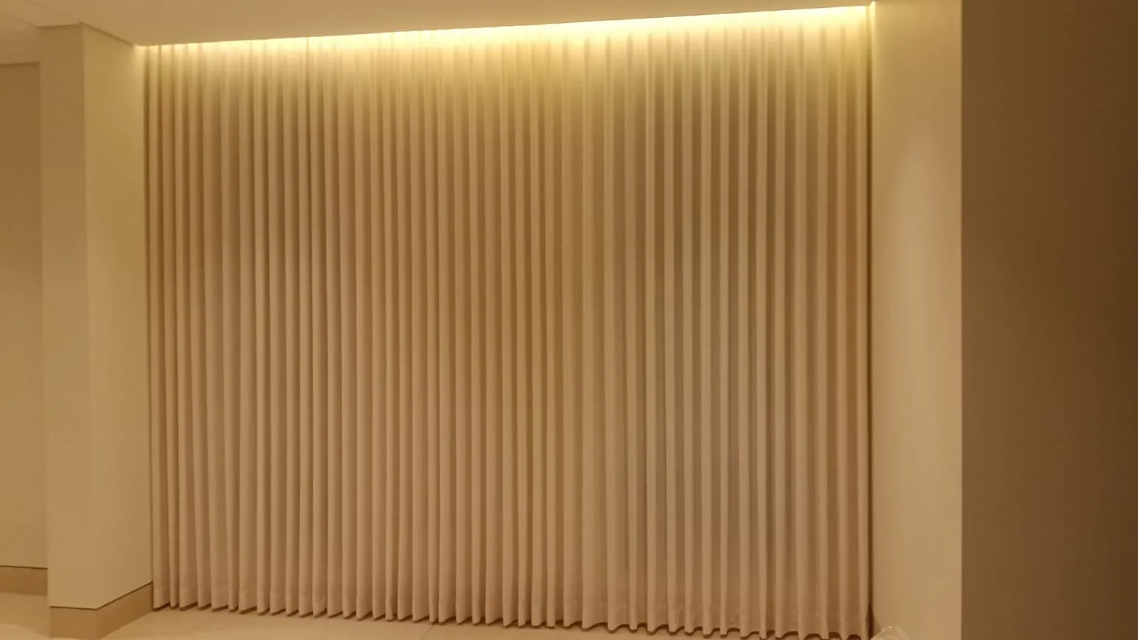 Cove lighting washing down a wave curtain wall in a Dammam project