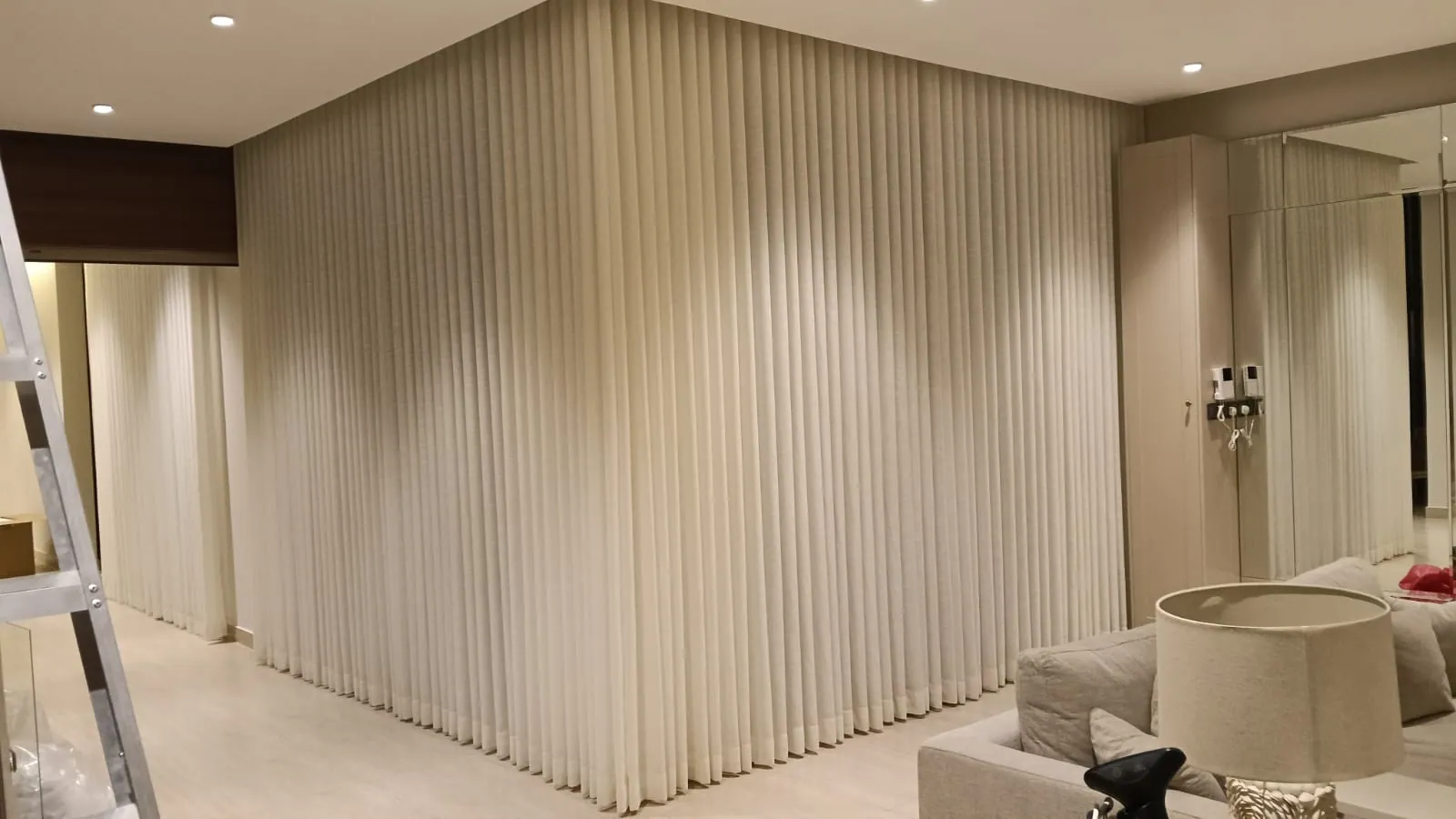 Corner wave curtain installation across two walls in a Dammam villa